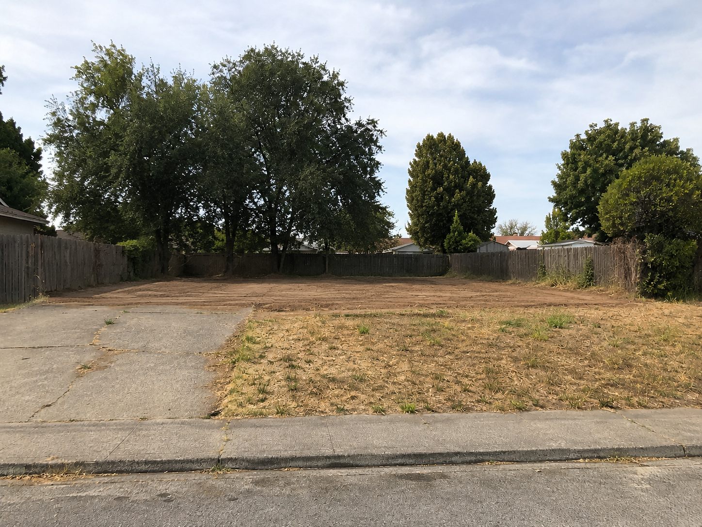 Cleared, graded lot after the home demolition