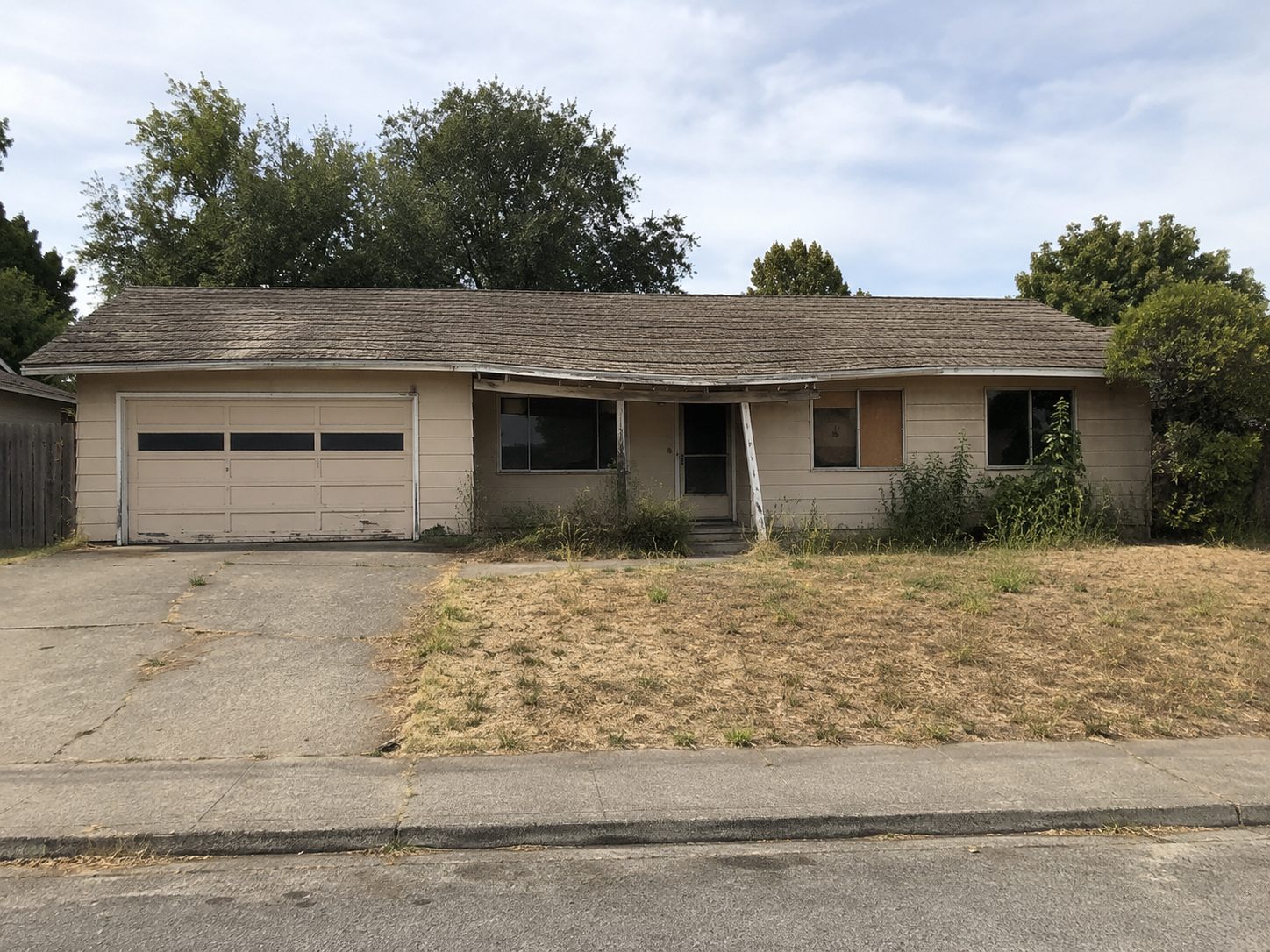 Abandoned single-story house before demolition