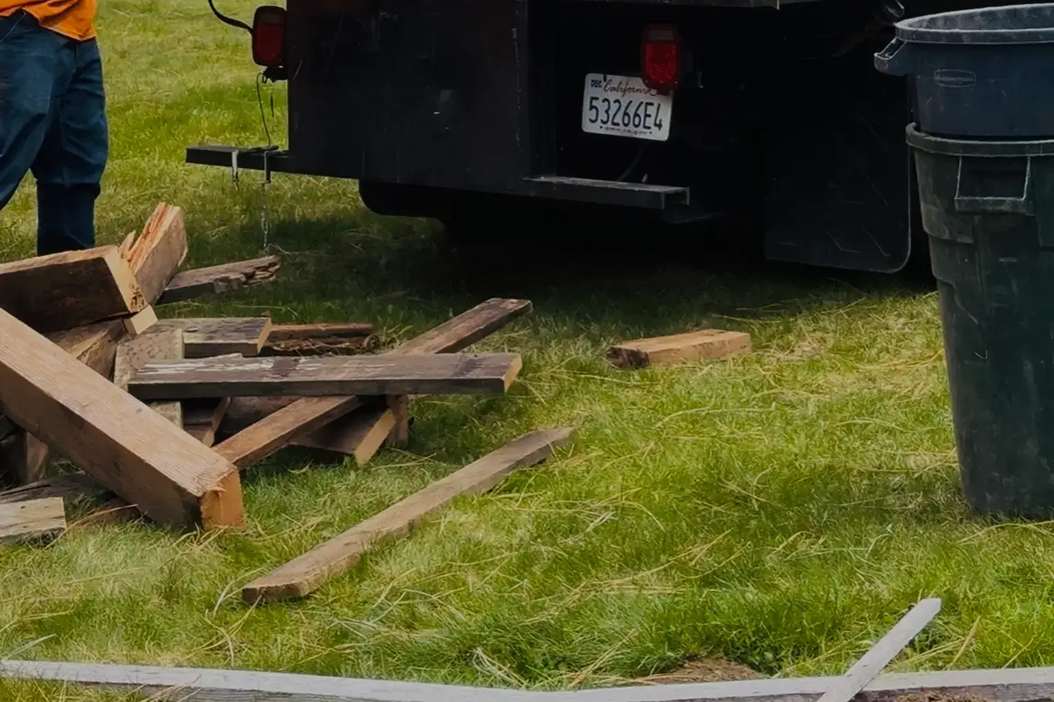 Crew loading construction debris and lumber into hauling truck