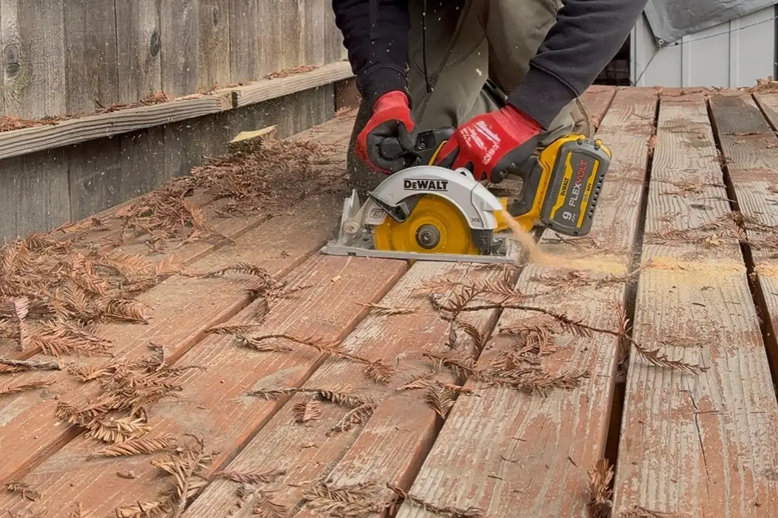 Beckett Siteworx crew cutting deck boards during deck demolition