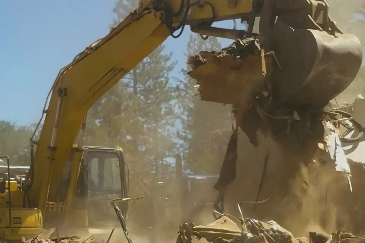 Excavator cleaning up demolition debris