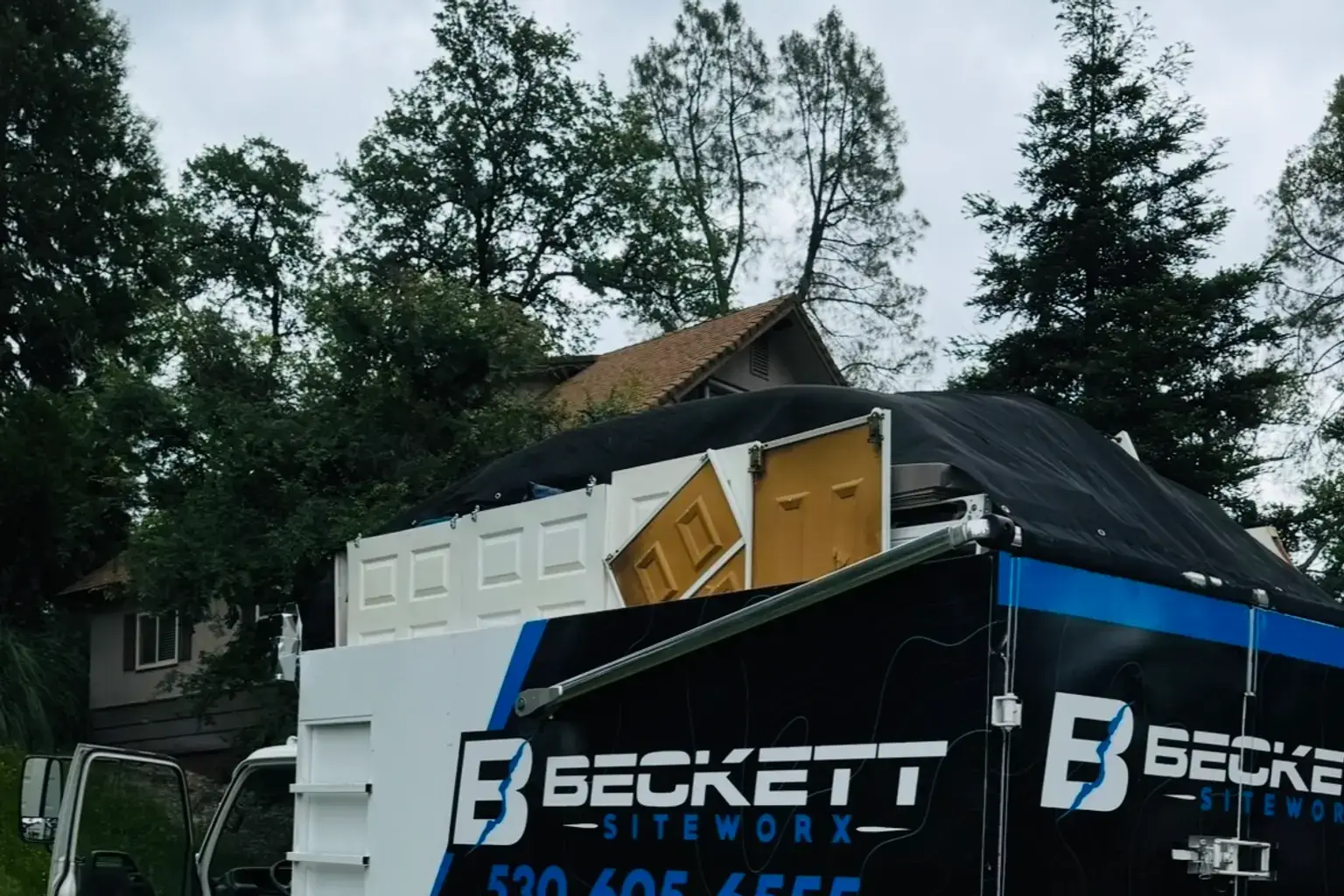 Junk removal truck loaded during a garage cleanout