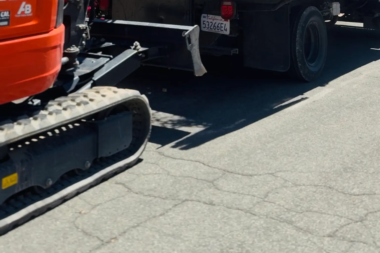 Mini excavator loading furniture during junk removal